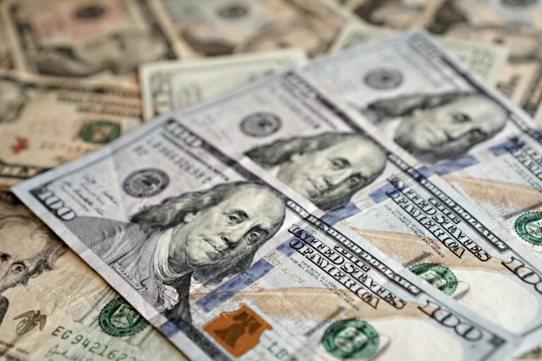 A stack of US dollar bills representing wealth, investment, and economic concepts.